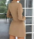 Vestido Blazer Curto Plissado Bege visto de costas em plano aproximado, evidenciando o corte na altura do quadril