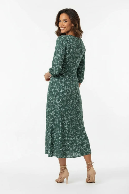 Vestido Feminino Longo Manga 3/4 Florido Verde visto de costas, mostrando o caimento rodado da saia midi