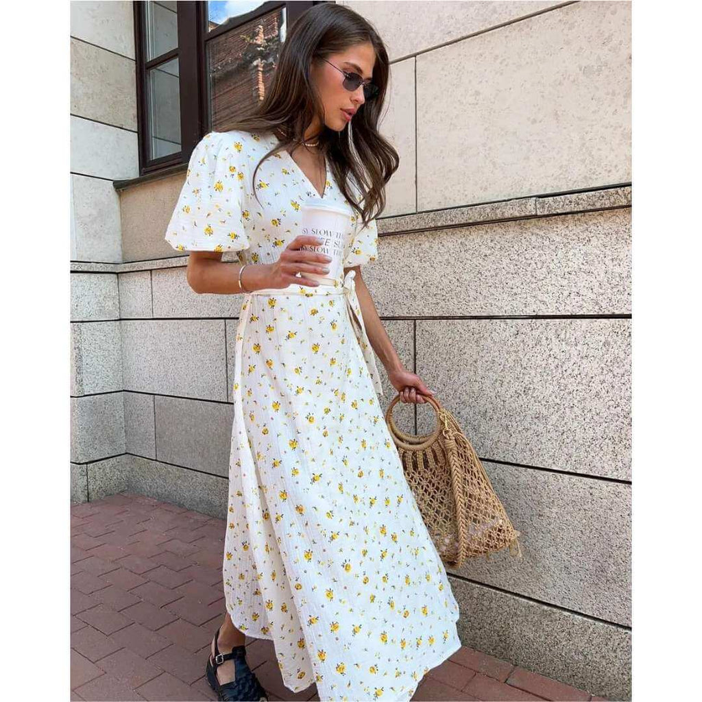 Vestido Feminino Midi Florido Amarelo em plano de meio corpo, destacando as mangas bufantes e a estampa floral