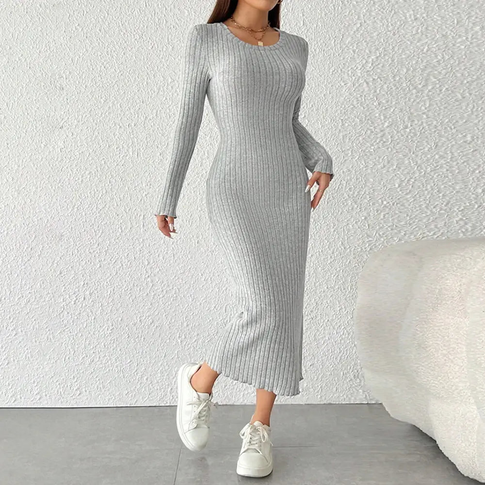 Vestido Longo de Malha Manga Longa cinza, visto de frente com caimento justo, canelado e tênis branco