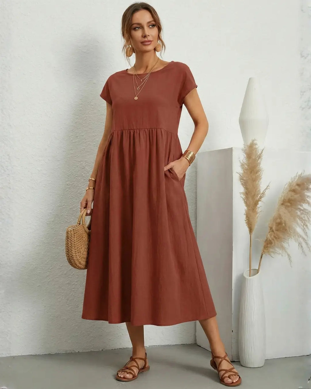 Vestido Midi Feminino Terracota em Algodão e Linho Estilo Boho com Bolsos visto de frente, com bolsa de palha e sandália rasteira